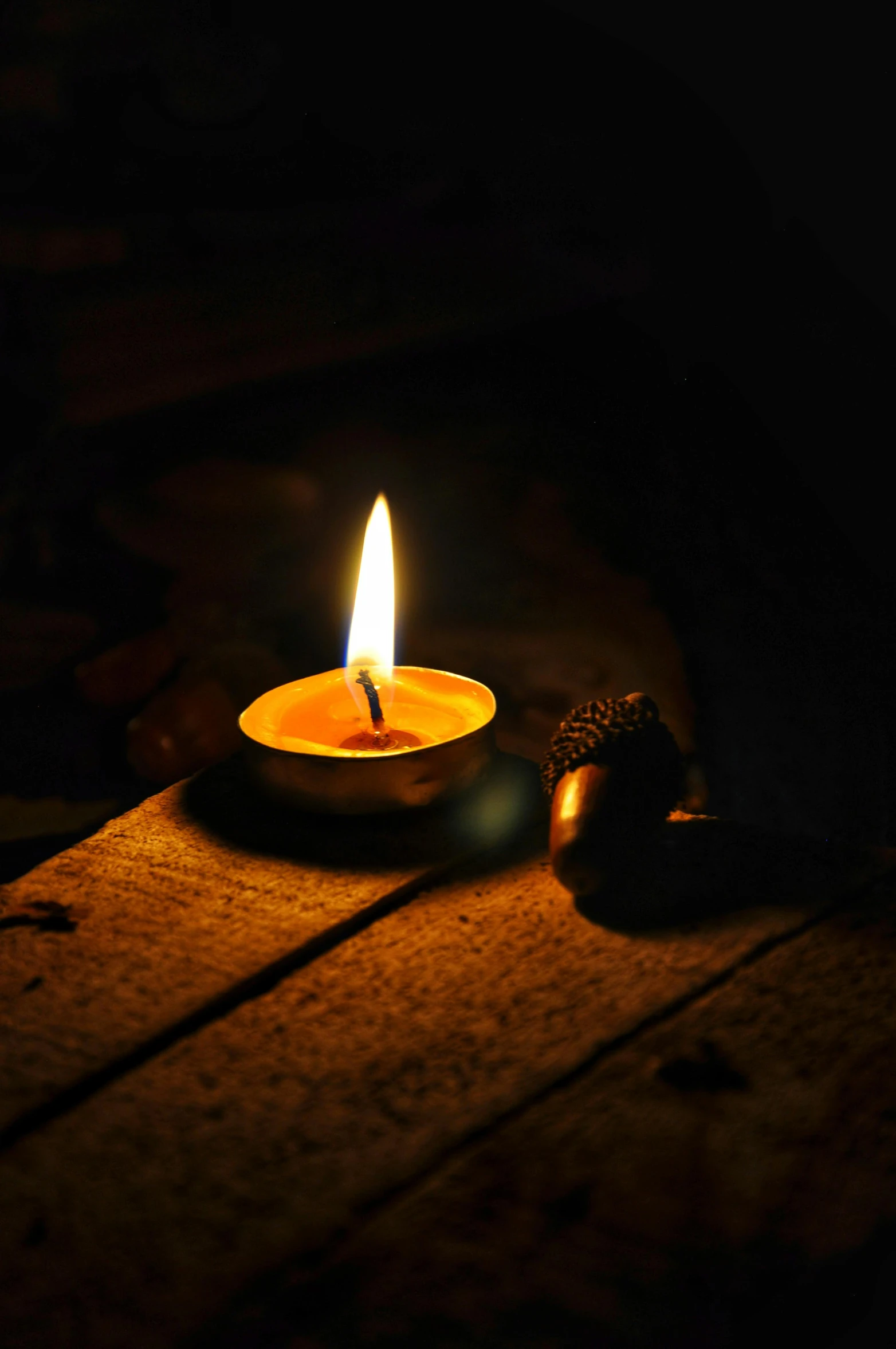 a lit candle sitting on top of a wooden table, laura watson, digital image, multiple stories, environmental