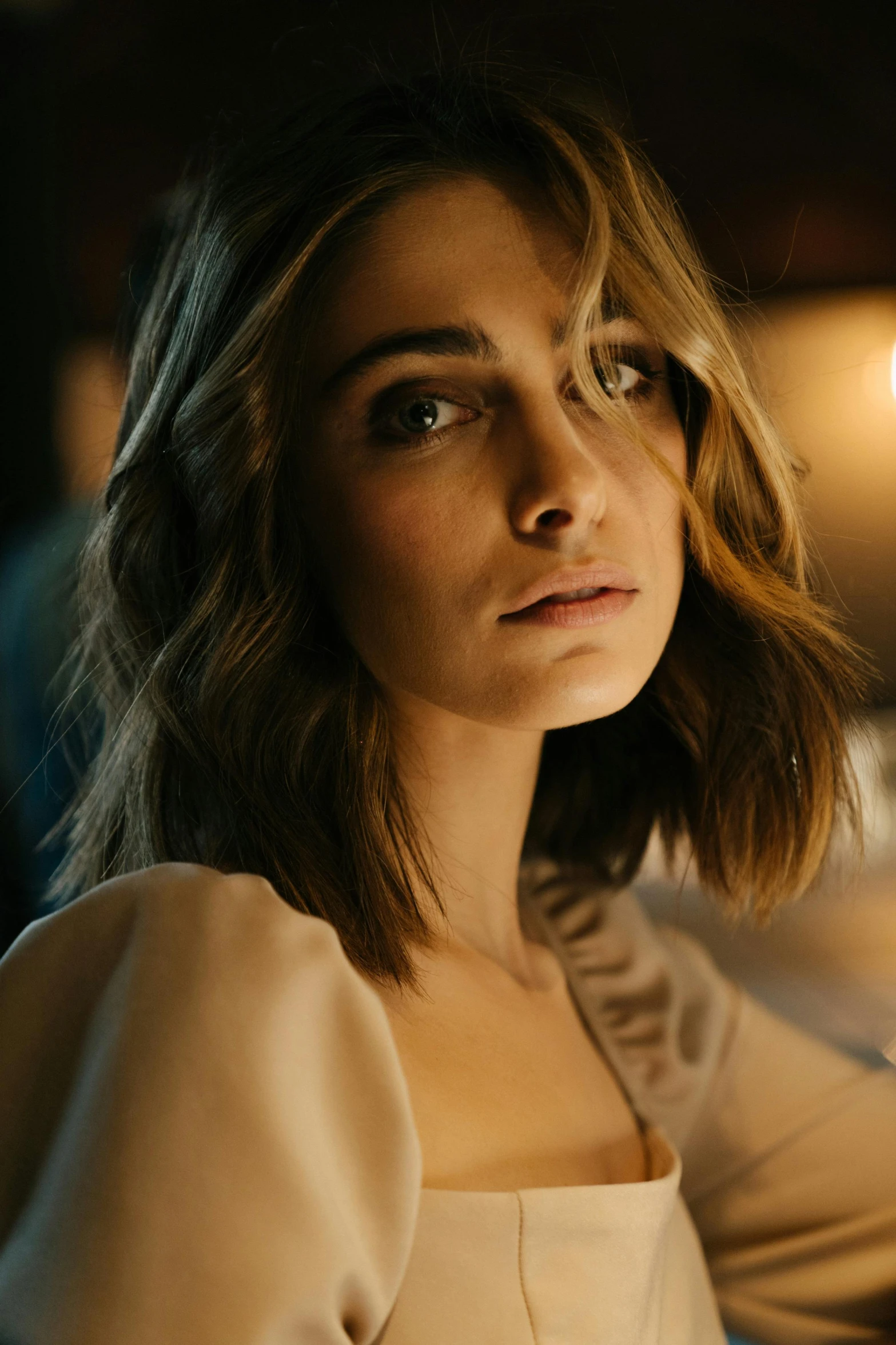 a woman sitting at a table with a glass of wine, a character portrait, inspired by Elsa Bleda, trending on pexels, natalia dyer, medium head to shoulder shot, soft lights, robe. perfect faces