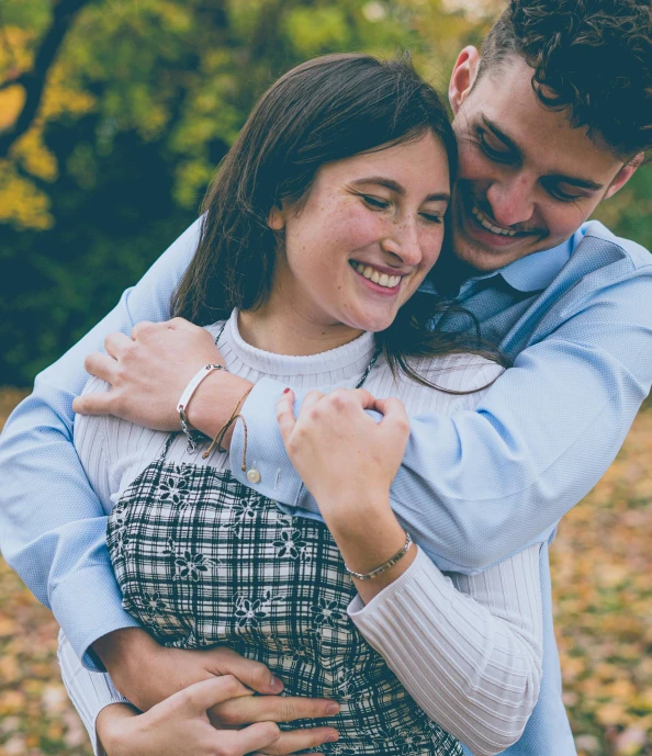 a man and woman hugging each other in a park, by Carey Morris, pexels, 15081959 21121991 01012000 4k, teenage girl, thumbnail, modeled