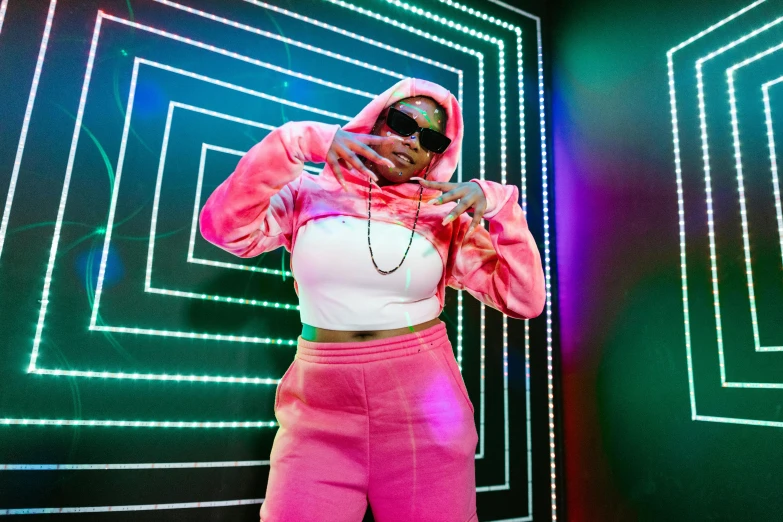 a woman in pink pants and a white top, an album cover, trending on pexels, thick neon lights, rapper bling jewelry, wearing a pink hoodie, shot on sony a 7 iii