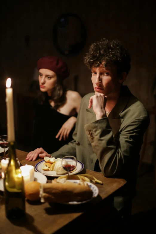 a couple of people sitting at a table with food, a portrait, pexels, renaissance, on a rough wooden dungeon table, sad man, scene from a dinner party, mousefolk