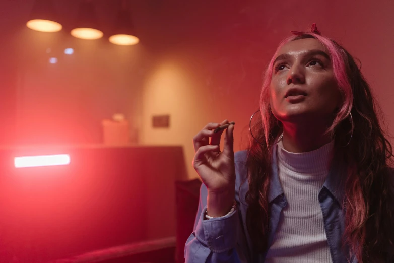 a woman smoking a cigarette in a dimly lit room, trending on pexels, serial art, red and blue neon, standing in a starbase bar, red haze, worksafe. cinematic
