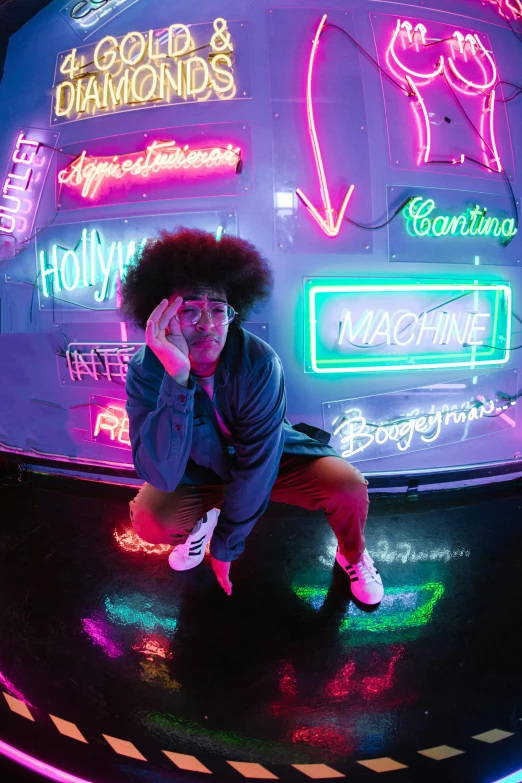 a woman sitting on the ground in front of neon signs, inspired by David LaChapelle, trending on pexels, black man with afro hair, andy milonakis, posing for a picture, light room