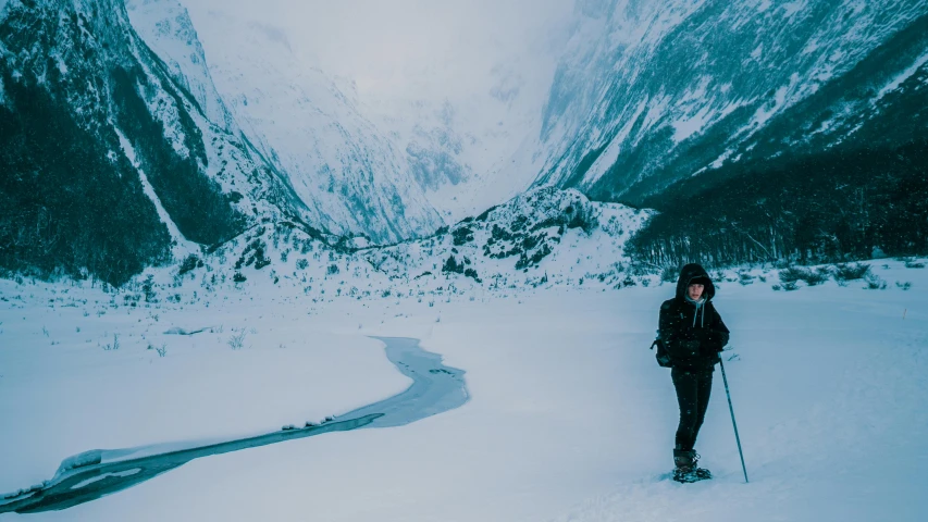 a man riding skis on top of a snow covered slope, pexels contest winner, she is walking on a river, avatar image, new zealand, cinematic outfit photo