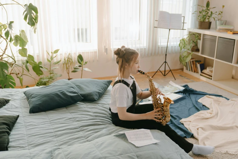 a girl sitting on a bed playing a saxophone, trending on pexels, squishy, studying, girl wearing uniform, long neck