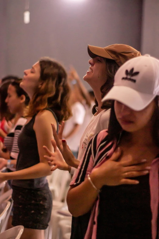 a group of people standing next to each other in a room, worship, in sao paulo, profile image, college girls