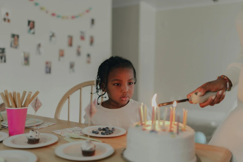 a little girl blowing out candles on a birthday cake, by Adam Marczyński, pexels contest winner, black teenage girl, gif, holding a candle holder, pals have a birthday party