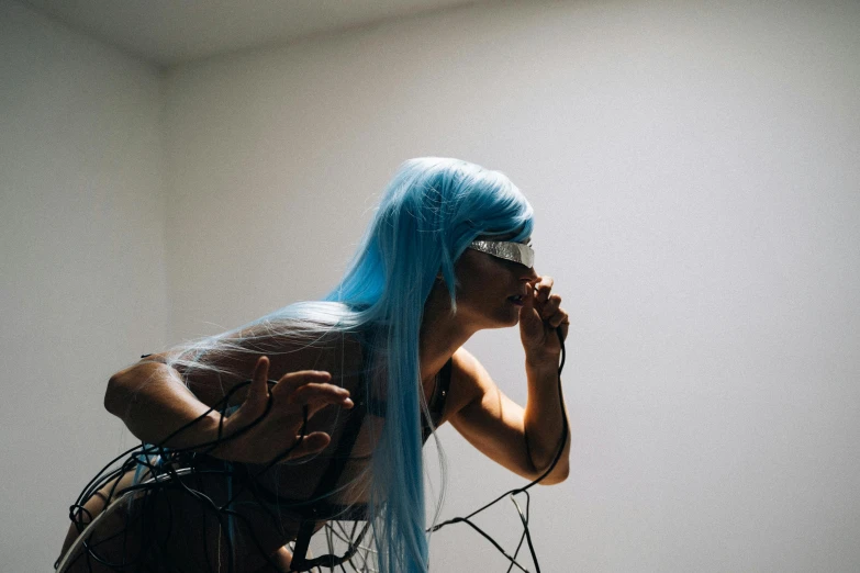 a woman with blue hair talking on a cell phone, unsplash, visual art, ahegao, cables on her body, chris cunningham, gif