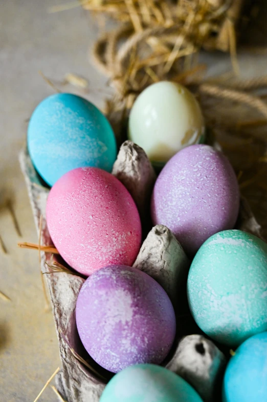 a basket filled with eggs sitting on top of a table, magical sparkling colored dust, carved soap, rhode island, chalked