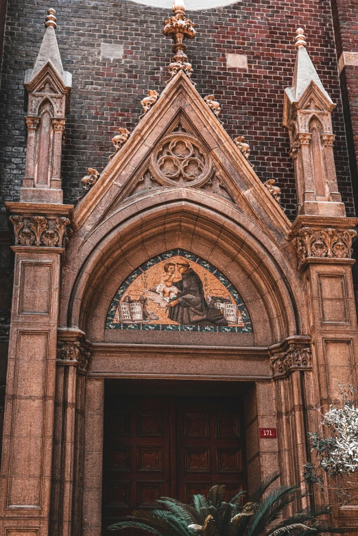 a building with a clock on the front of it, a photo, inspired by Carlo Crivelli, gothic arch frame, brown, entrance, catholic