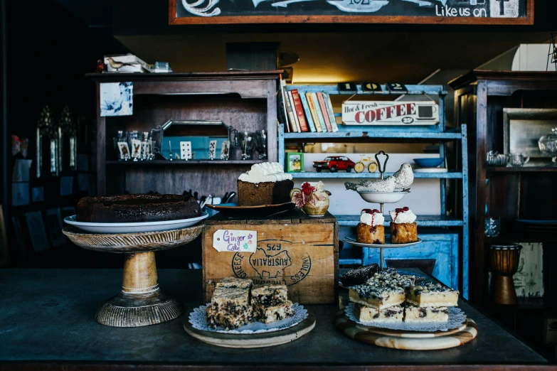 a table topped with lots of cakes and pastries, by Lee Loughridge, unsplash, in chippendale sydney, rustic and weathered, 90s photo, blue