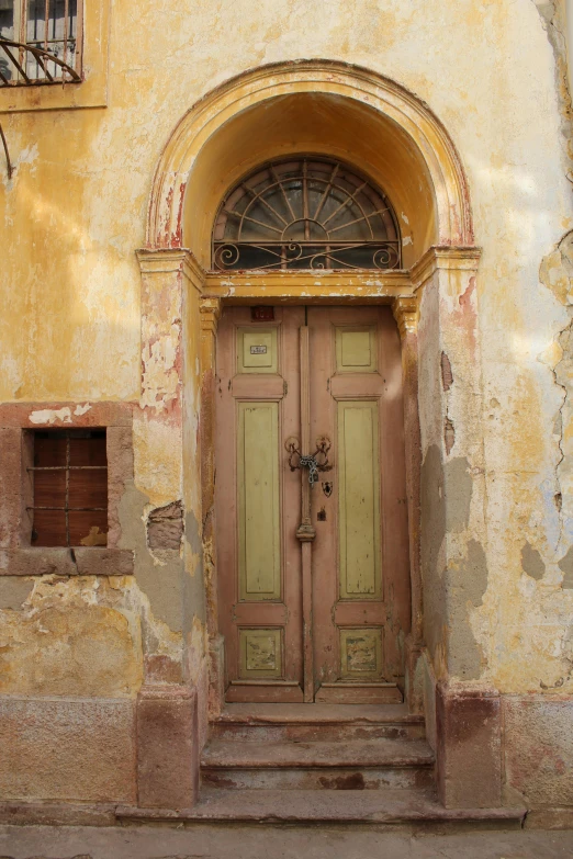 a wooden door sitting on the side of a building, a picture, flickr, baroque, ancient ochre palette, crumbling ruins, naboo, square