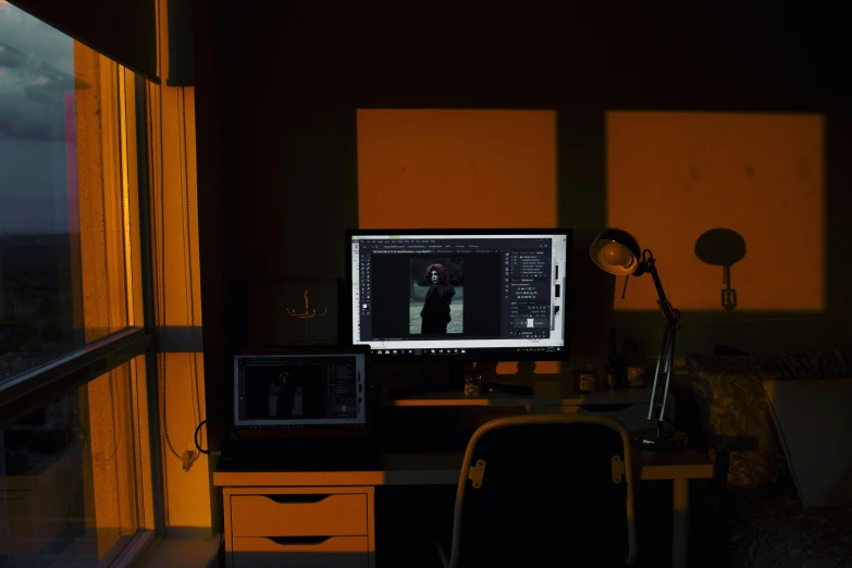 a computer sitting on top of a desk next to a window, inspired by Elsa Bleda, computer art, dramatic lowkey studio lighting, horror lighting, light source from the left, computer screens