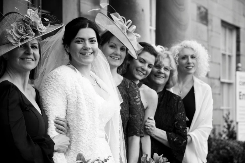 a group of women standing next to each other, a black and white photo, by John Hutton, flickr, luxurious wedding, lena oxton, award-winning style, veil