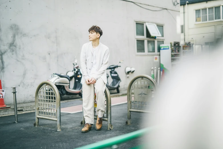 a man sitting on a bench in front of a building, a picture, unsplash, shin hanga, white!!, 15081959 21121991 01012000 4k, keisuke goto, hyung tae
