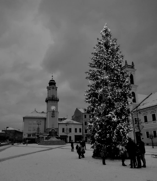 a black and white photo of a christmas tree, by Ilka Gedő, pexels contest winner, baroque, small town, square, sky!!!, (snow)