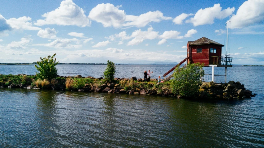 a small red building sitting on top of a body of water, by Julia Pishtar, tarmo juhola, thumbnail, vacation photo, listing image