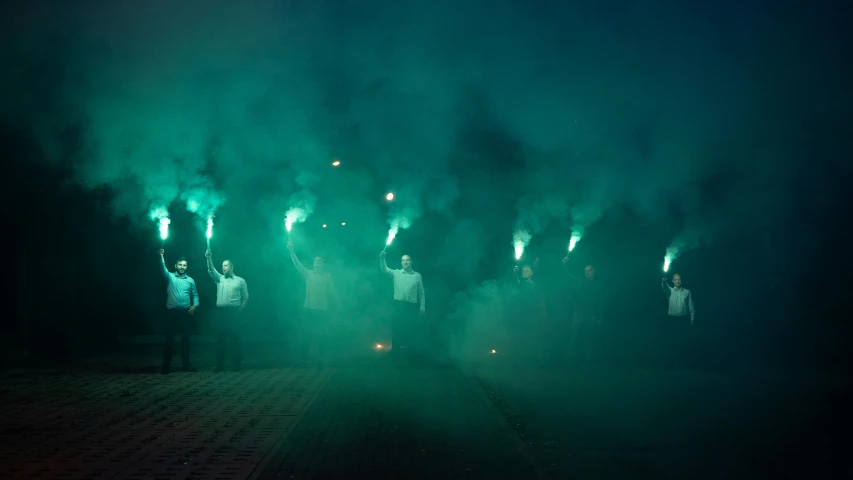 a group of people that are standing in the dark, green smoke, wall torches, gintas galvanauskas, green flags