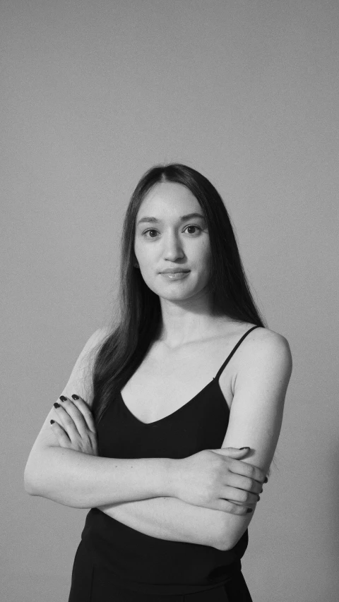 a black and white photo of a woman with her arms crossed, inspired by Fei Danxu, reddit, young woman with long dark hair, professional profile photo, simin stalenhag, headshot profile picture