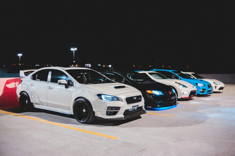 a row of cars parked in a parking lot at night, inspired by An Gyeon, unsplash, subaru, square, white metallic, various posed