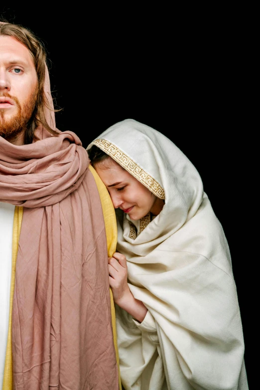 a man and woman dressed as jesus and mary, inspired by Geertgen tot Sint Jans, unsplash, wrapped arms, looking sideway, slide show, ( ( theatrical ) )