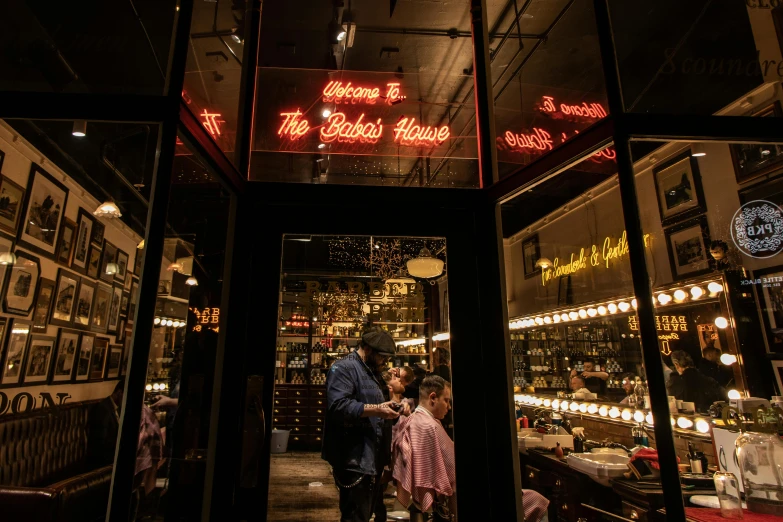 a couple of people standing in front of a store, by Adam Saks, pexels contest winner, lipstick, speakeasy, warm lighting inside, in chippendale sydney