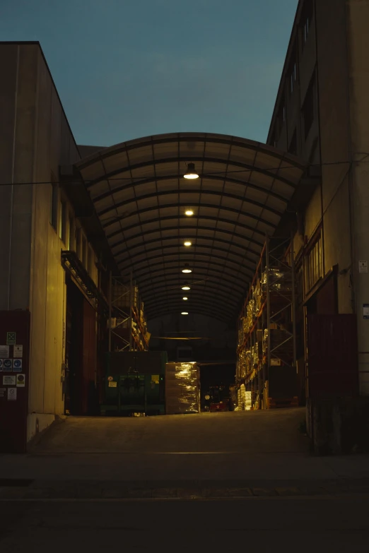 a warehouse filled with lots of boxes under a blue sky, inspired by Elsa Bleda, quiet tokyo alley at night, leica 8k still from an a24 film, dry archways, worksafe. cinematic