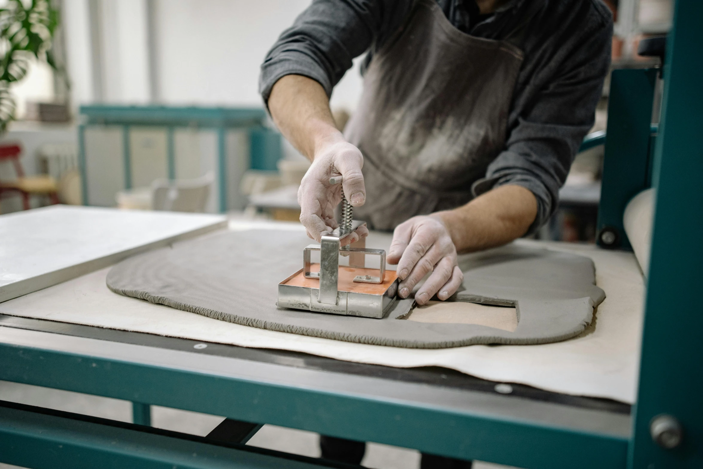 a man is working on a piece of wood, a silk screen, unsplash, arbeitsrat für kunst, made of cement, introduction factory photo, thumbnail, luxury materials