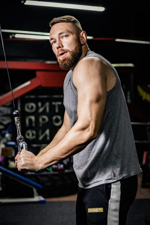 a man holding a rope in a gym, a portrait, by Alexander Fedosav, reddit, square, bearded, high quality photo, sleeveless