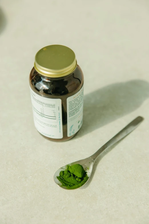 a spoon that is sitting on a table, green body, nootropic stimulant, bottle, jen atkin