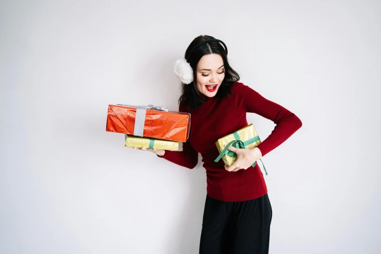 a woman in a red sweater holding two wrapped presents, pexels contest winner, happening, with a white background, avatar image, various posed, profile image