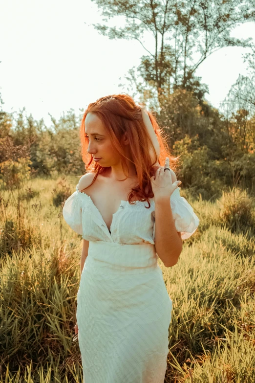 a woman in a white dress standing in a field, inspired by Elsa Bleda, pexels contest winner, renaissance, curly copper colored hair, better known as amouranth, low quality photo, album cover