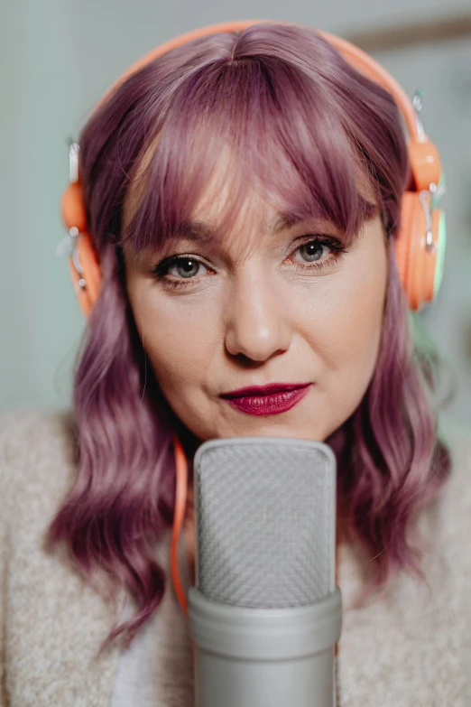 a woman with headphones sitting in front of a microphone, inspired by Grethe Jürgens, antipodeans, lilac hair, straight camera view, promo image, youtuber