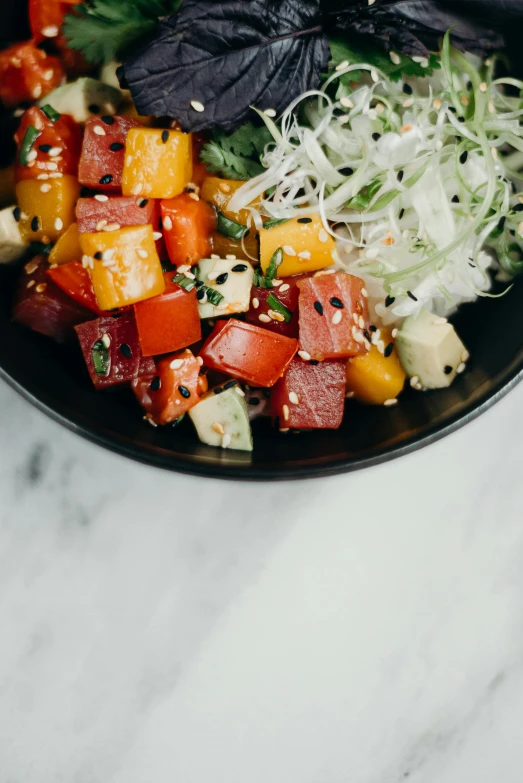 a close up of a bowl of food on a table, inspired by Kanō Tan'yū, unsplash, dau-al-set, multi colored, square, salad, slate