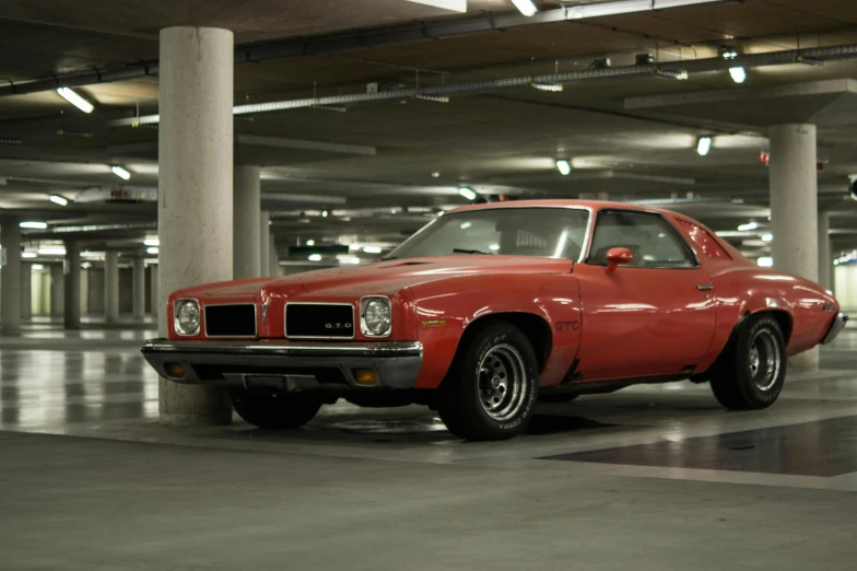 a red car parked in a parking garage, pexels contest winner, photorealism, pacman, muscle cars, square, high quality upload