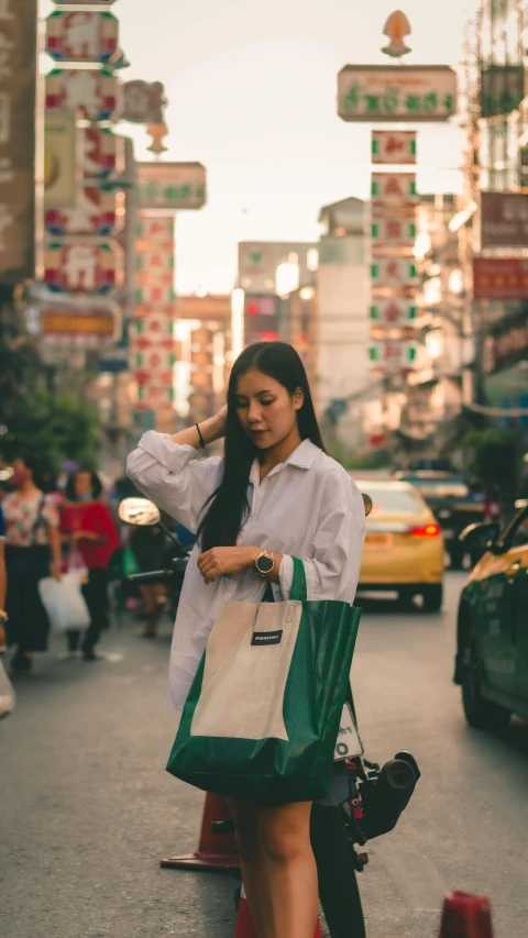 a woman is walking down the street with a bag, inspired by Wang E, unsplash contest winner, bangkok townsquare, sea - green and white clothes, casual pose, ethnicity : japanese