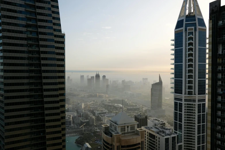 a view of a city from a high rise building, by Daniel Lieske, pexels contest winner, hurufiyya, morning haze, middle eastern, 2 0 2 2 photo, 2006 photograph