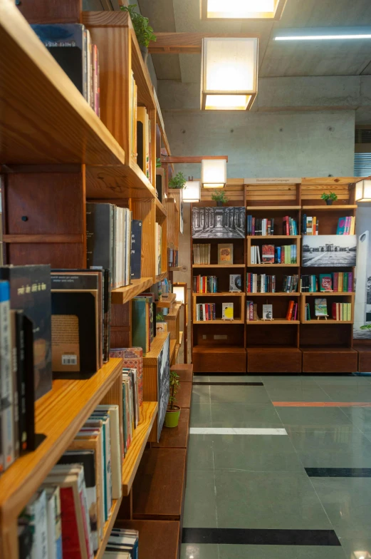 a bookshelf filled with lots of books in a library, unsplash, modernism, inside of a tokyo garage, official store photo, contain