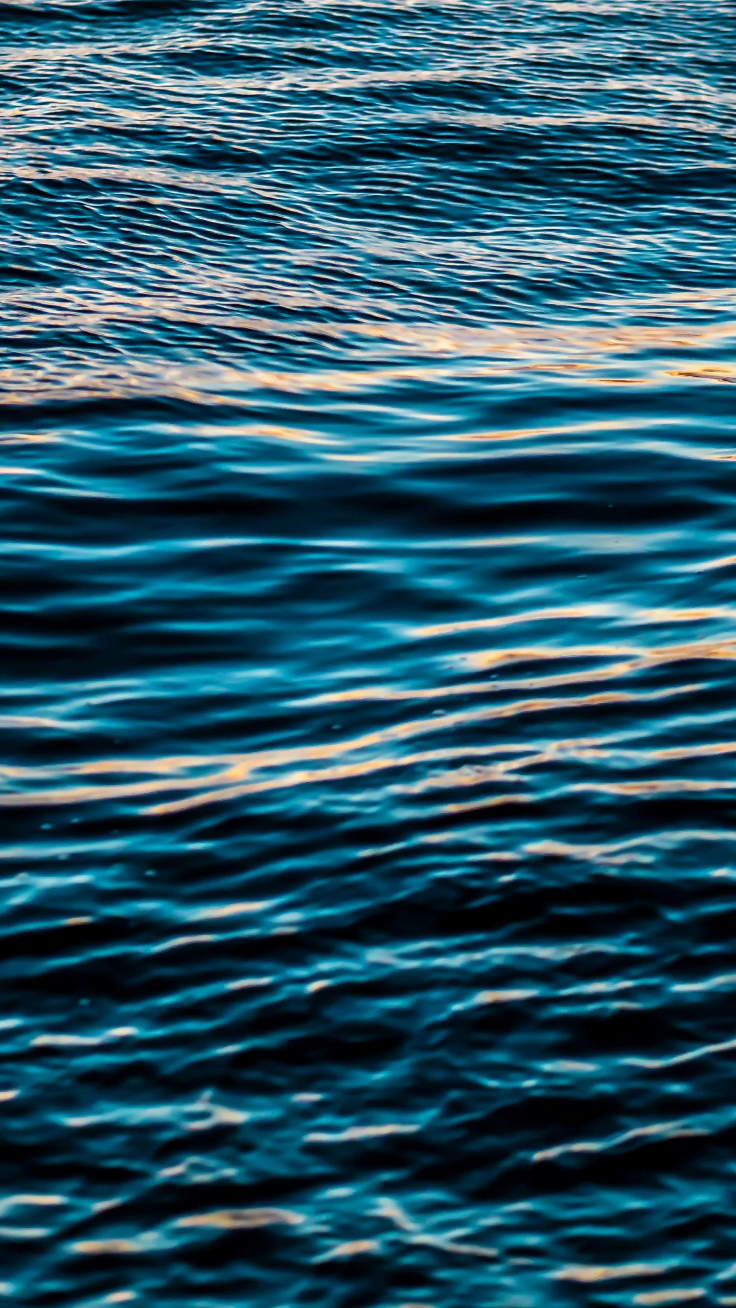 a person riding a surfboard on top of a body of water, an album cover, inspired by Elsa Bleda, unsplash, minimalism, extremely detailed water texture, dark blue color, middle close up shot, curved lines