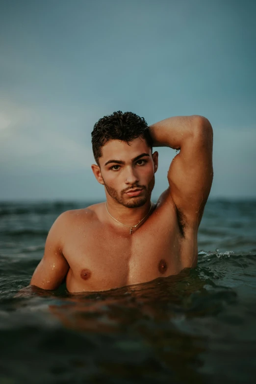 a man that is standing in the water, by Adam Dario Keel, trending on pexels, renaissance, attractive beefy man, olive skin color, non binary model, zayn malik