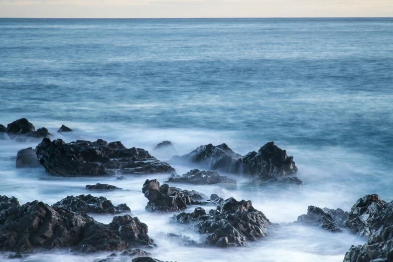 a group of rocks sitting on top of a body of water, pexels contest winner, australian tonalism, azure waves of water, spikey rocks, maui, 8k resolution”