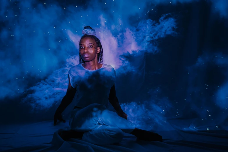 a woman sitting on top of a bed covered in blue smoke, afrofuturism, in a space starry, black light, portrait of ororo munroe, sitting on the cosmic cloudscape