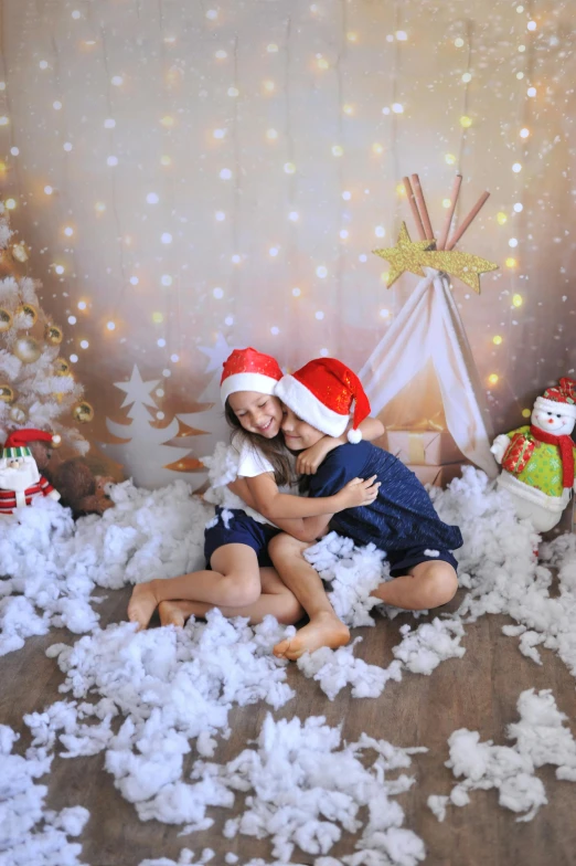 a couple of kids sitting on top of a pile of snow, by Julia Pishtar, fine art, wearing santa hat, non-illuminated backdrop, cardboard, te pae