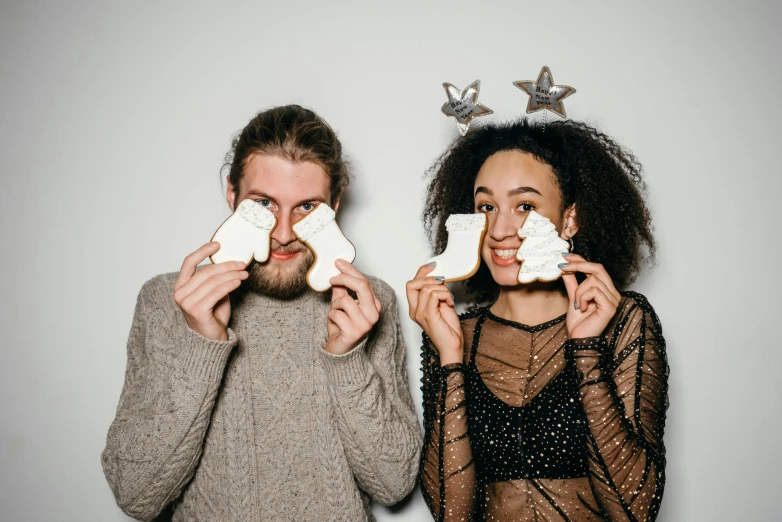 a couple of people standing next to each other, pexels contest winner, renaissance, cookies, white horns from eyebrows, black on white background, holiday vibe