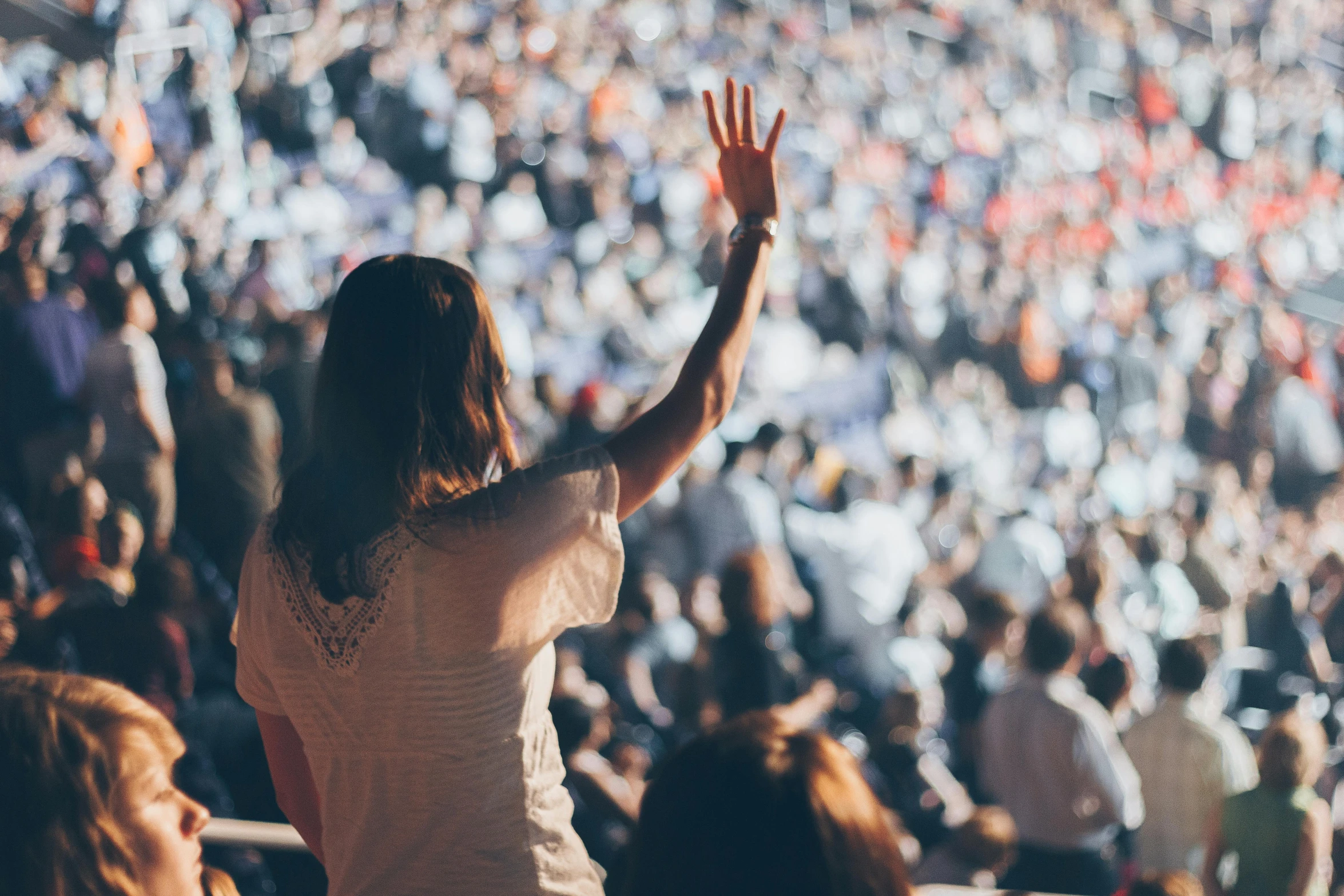 a woman standing in front of a crowd at a concert, pexels, crowds of people praying, interrupting the big game, people at work, birdseye view