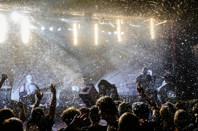 a group of people that are standing in the snow, pexels contest winner, figuration libre, live concert lighting, flowers exploding and spraying, stoner rock concert, thumbnail