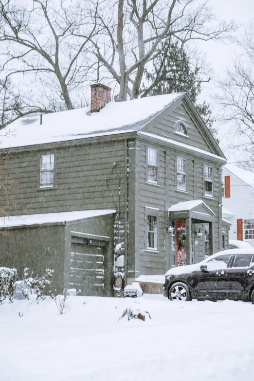 a car parked in front of a house in the snow, a colorized photo, by Pamela Drew, pexels contest winner, panoramic shot, new england architecture, nice slight overcast weather, a wooden