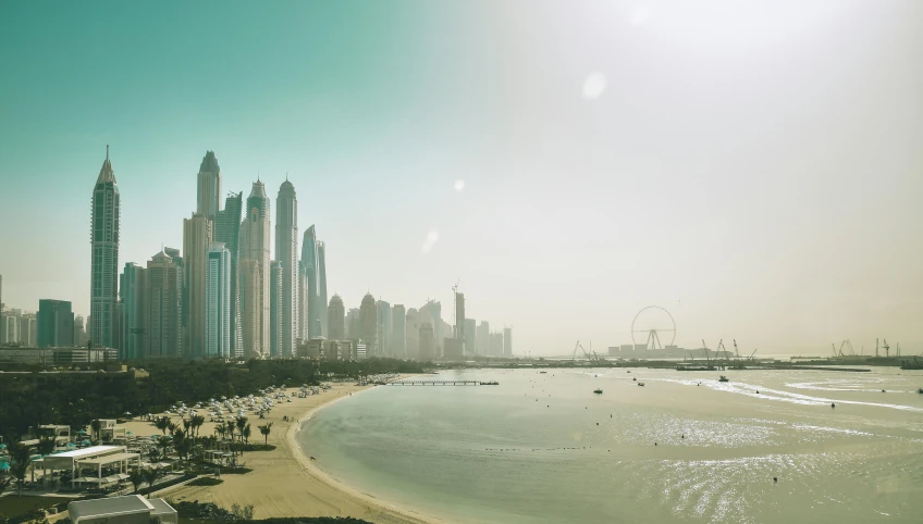 a view of a beach with a city in the background, pexels contest winner, hyperrealism, dubai, sunfaded, multiple views, white pale concrete city