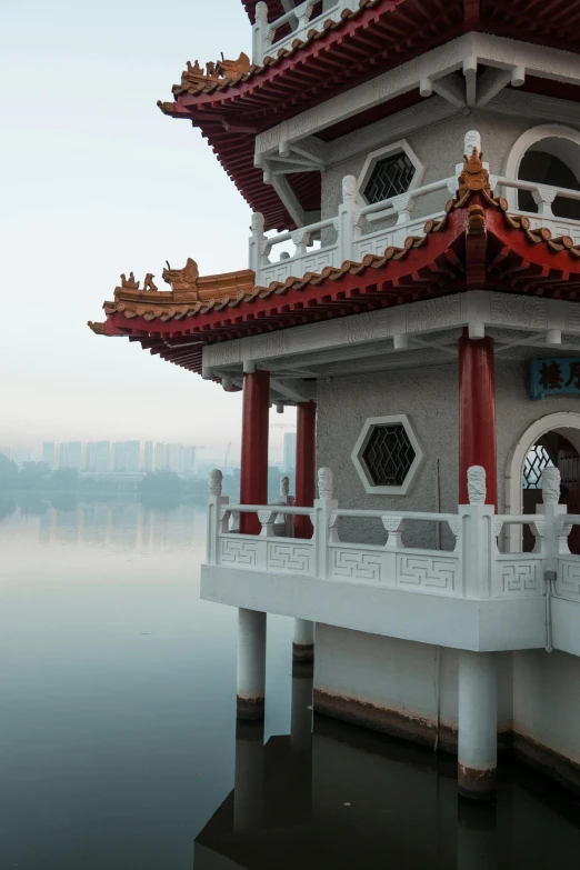 a pagoda sitting on top of a body of water, inspired by An Zhengwen, minimalism, shenzhen, detail shot, harbour, tai chi