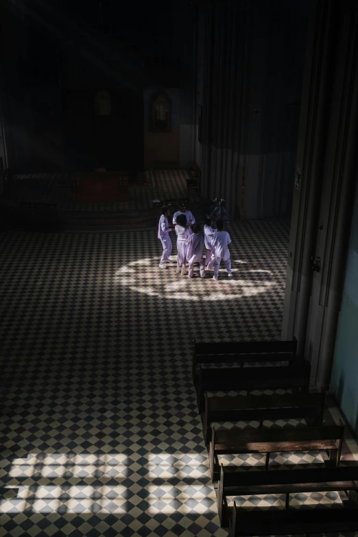 a couple of benches sitting on top of a checkered floor, inspired by Gregory Crewdson, interior of the old cathedral, dancers, null, séance